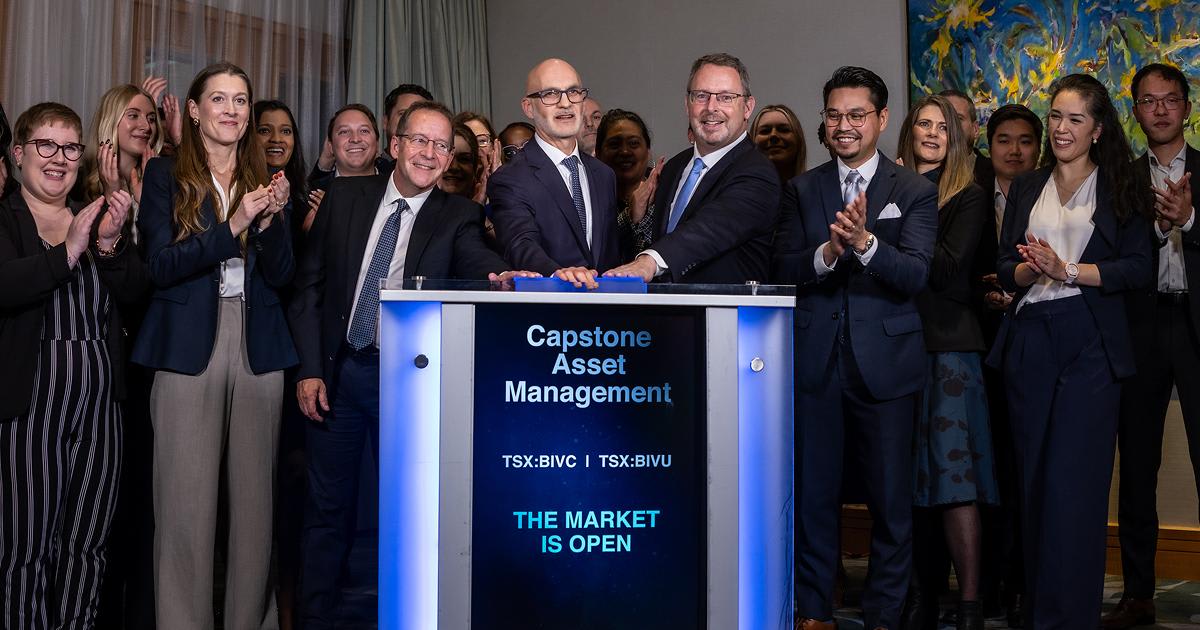 A group of team celebrating the opening of the market at a launch event.