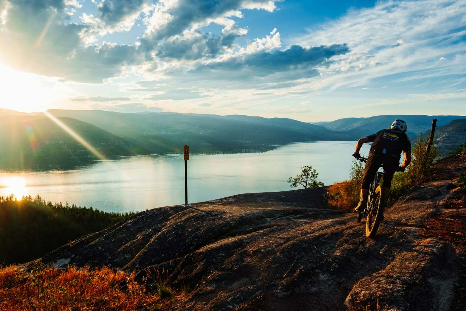 Slab rock to the edge, Okanagan Lake below. This is Rock Garden Playground at the end of the day. Photo: Aaron Thiessen, Whisky Ginger Media | Predator Ridge Trails