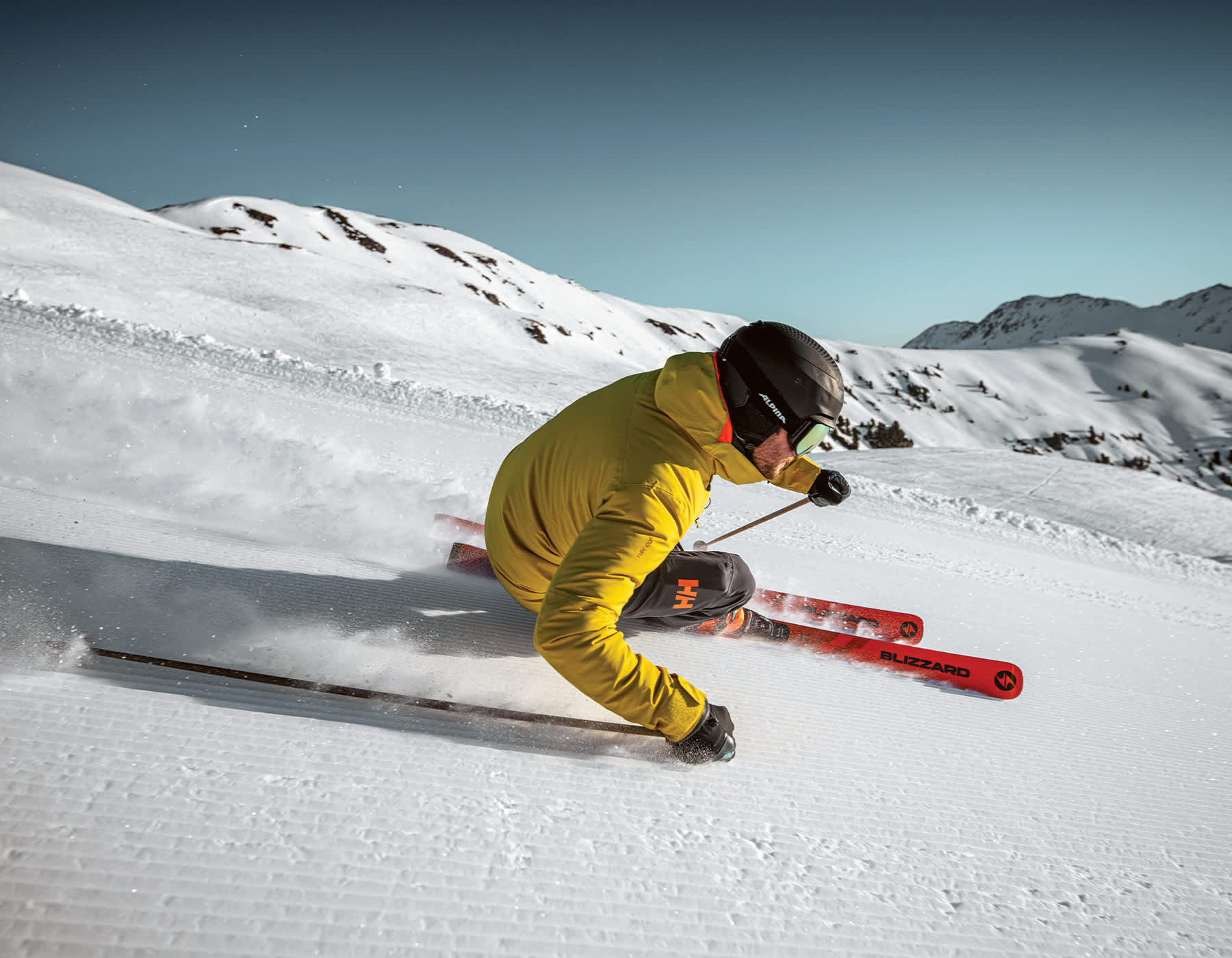 Shop Blizzard Skis Kelowna. Alpine skier carving on Blizzard skis