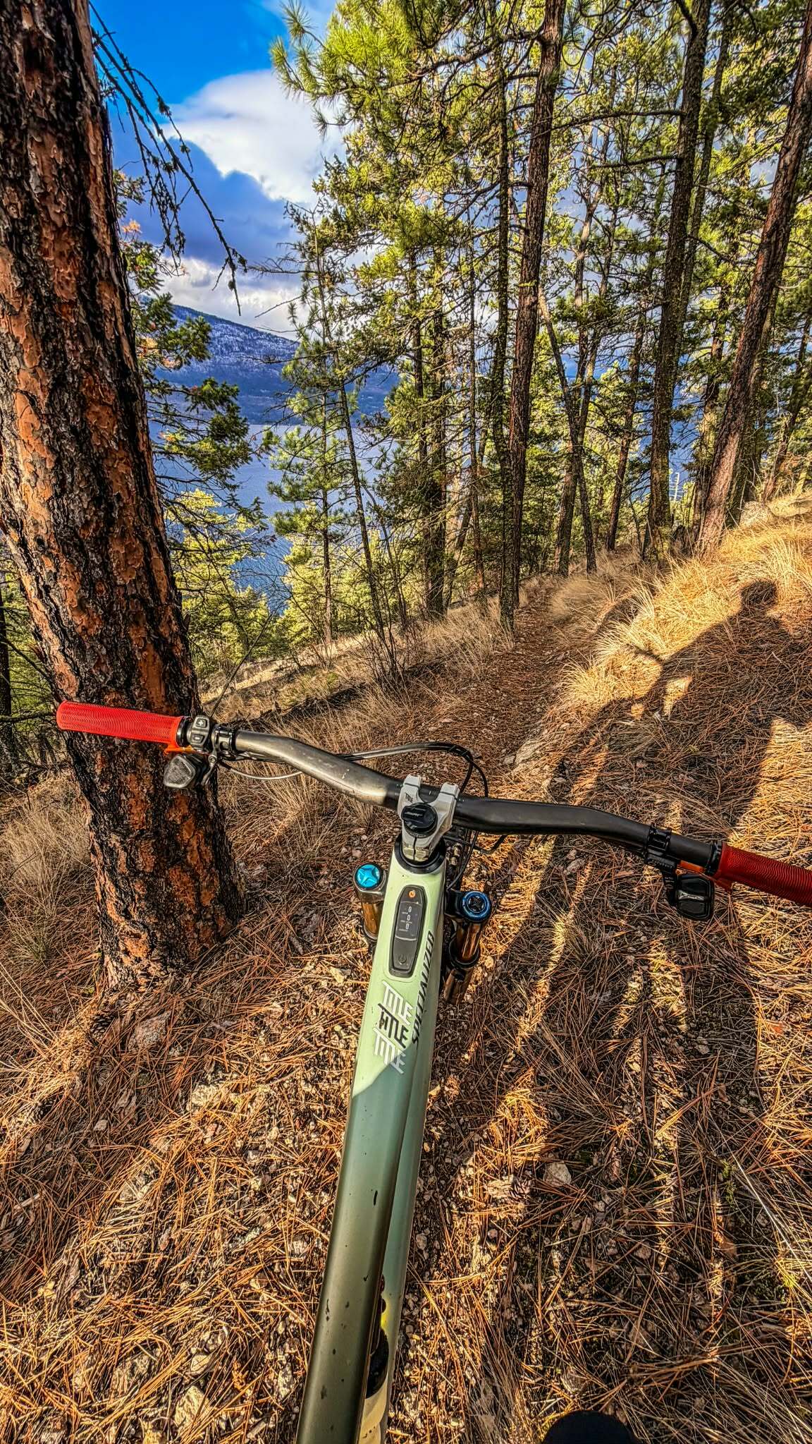 mountain bike on the trails at predator ridge with a view of okanagan lake 