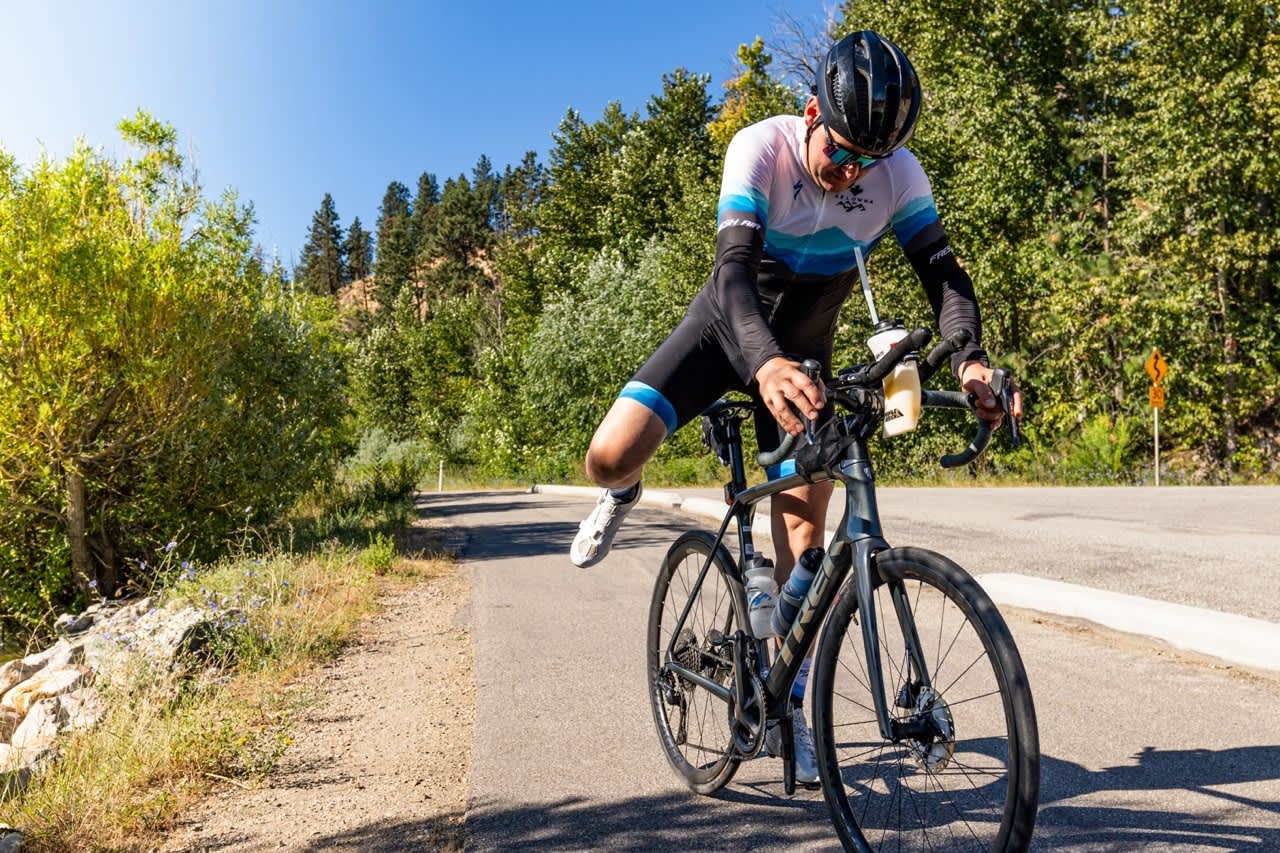 A man riding a bike at the annual Fresh Air Kelowna Cherry Blossom Triathlon