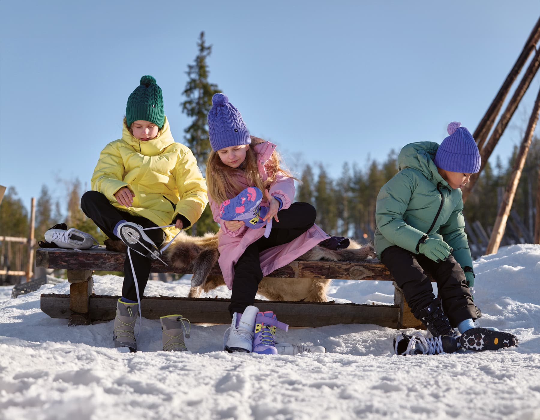 Arc’teryx ambassadors. A group of Arc'teryx ambassadors wearing jackets, sitting on rocks with mountains in the background