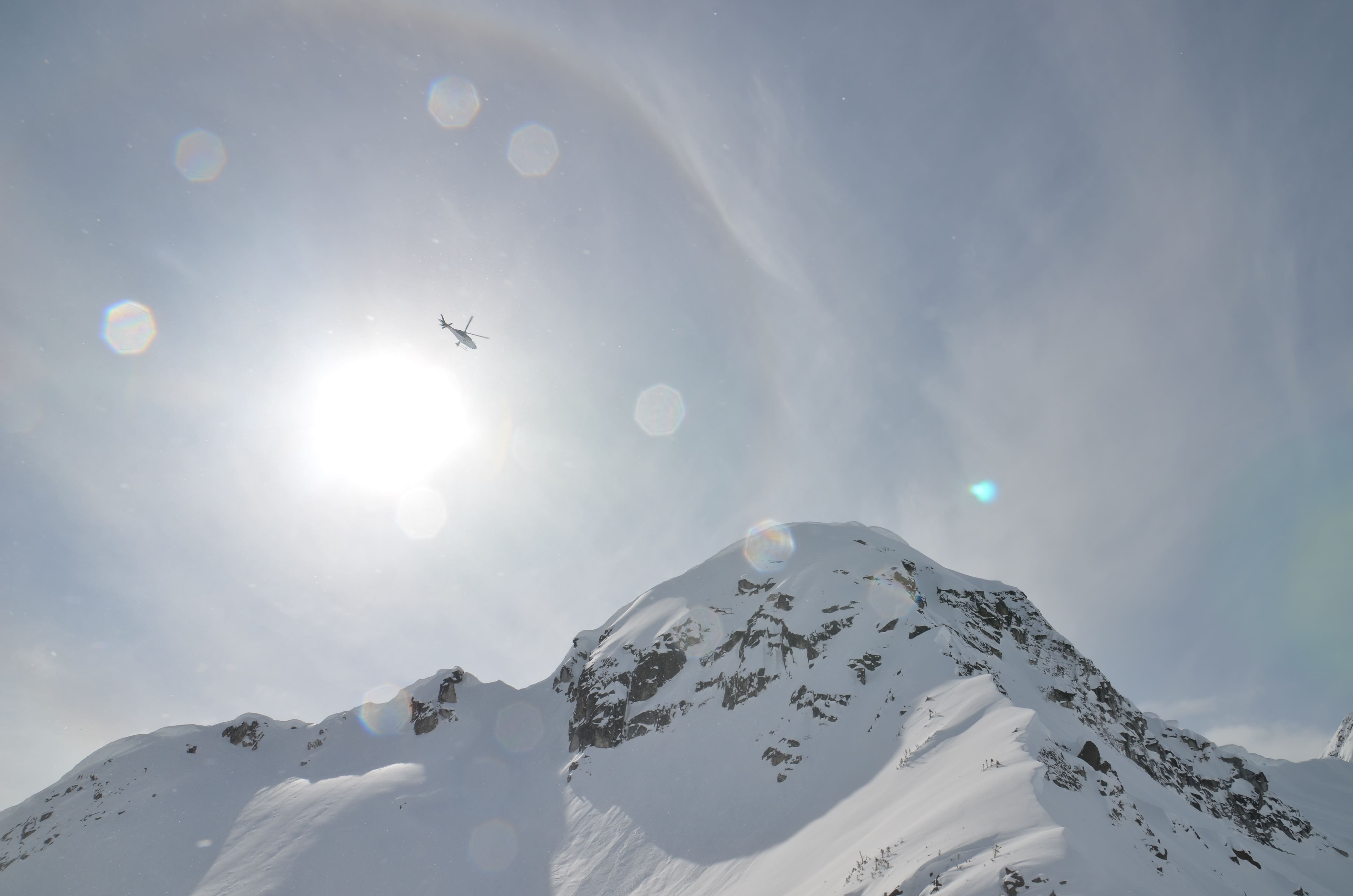 High above the peaks, adventure awaits—deep powder skiing starts where the helicopter lands.