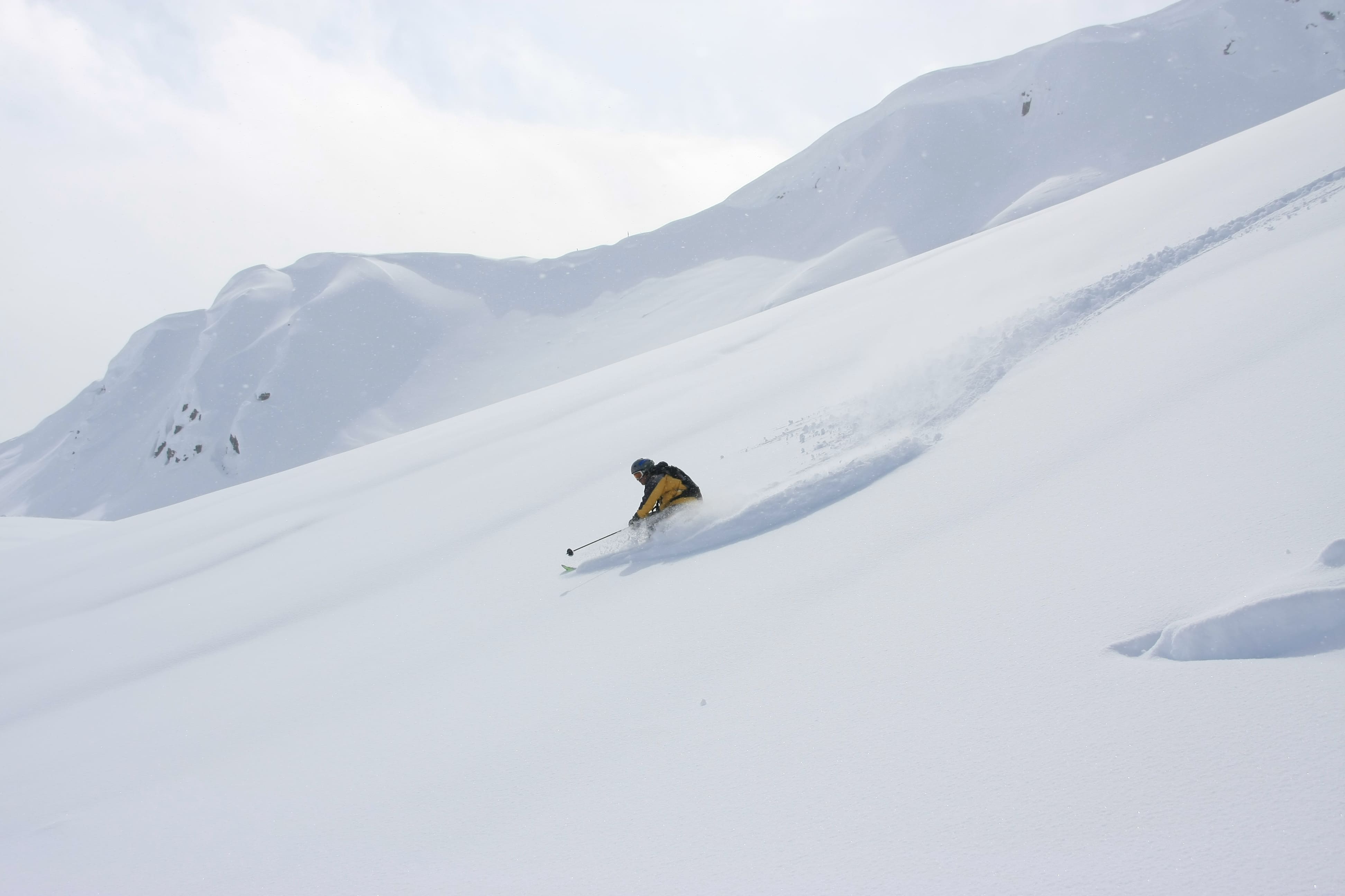Carving through deep powder at Northern Escape Heli-skiing—pure Canadian mountain adventure!