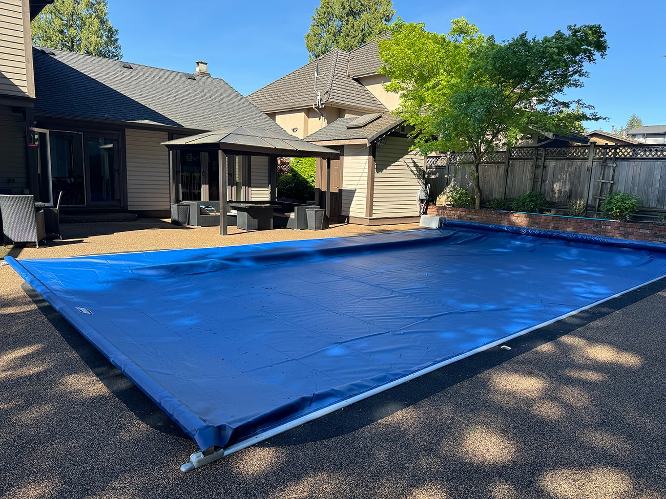 New, properly installed automatic pool cover fabric not only provides a superior level of safety for your backyard but looks great, too!