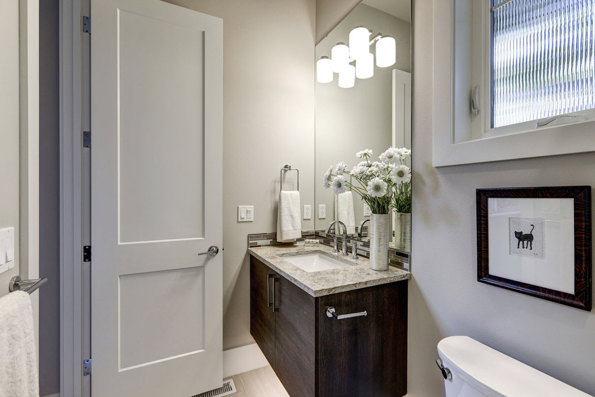 A large mirror can make a cramped half bath feel more spacious. 