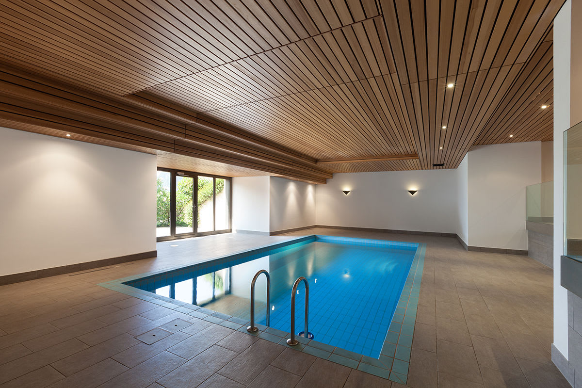 An indoor lap pool takes up little space and can be accented with decking by the pool companies Kelowna recommend.