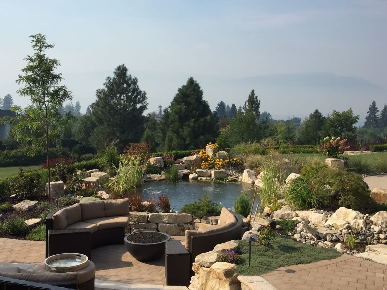 Koi Pond featuring a stone bridge, a versatile hardscape element for all landscapes!